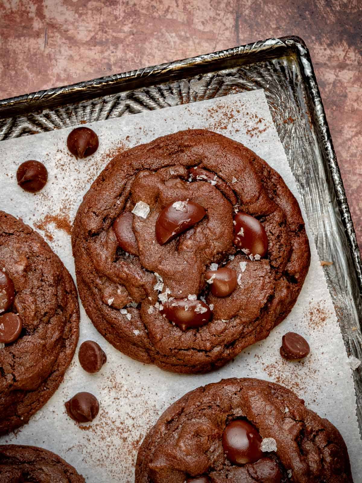 double chocolate chip espresso cookies on a cookie sheet with flaky sea salt