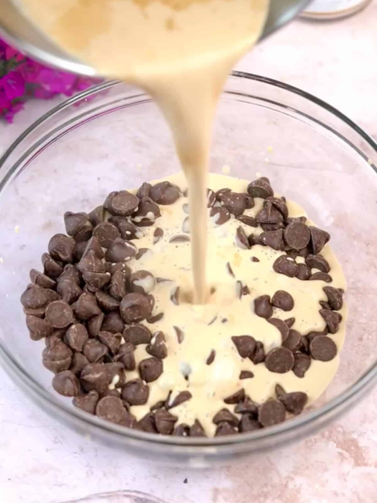 espresso cream being poured over chocolate chips