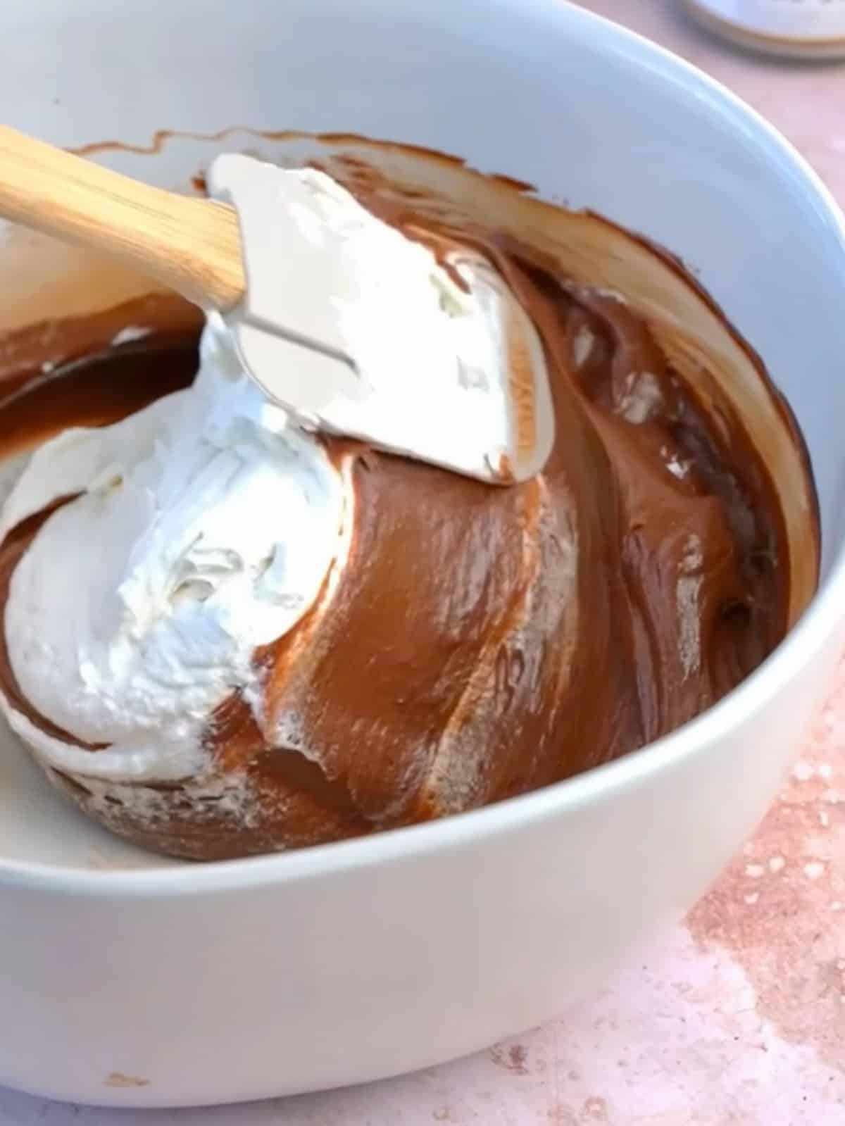 folding whipped cream into the chocolate espresso mixture