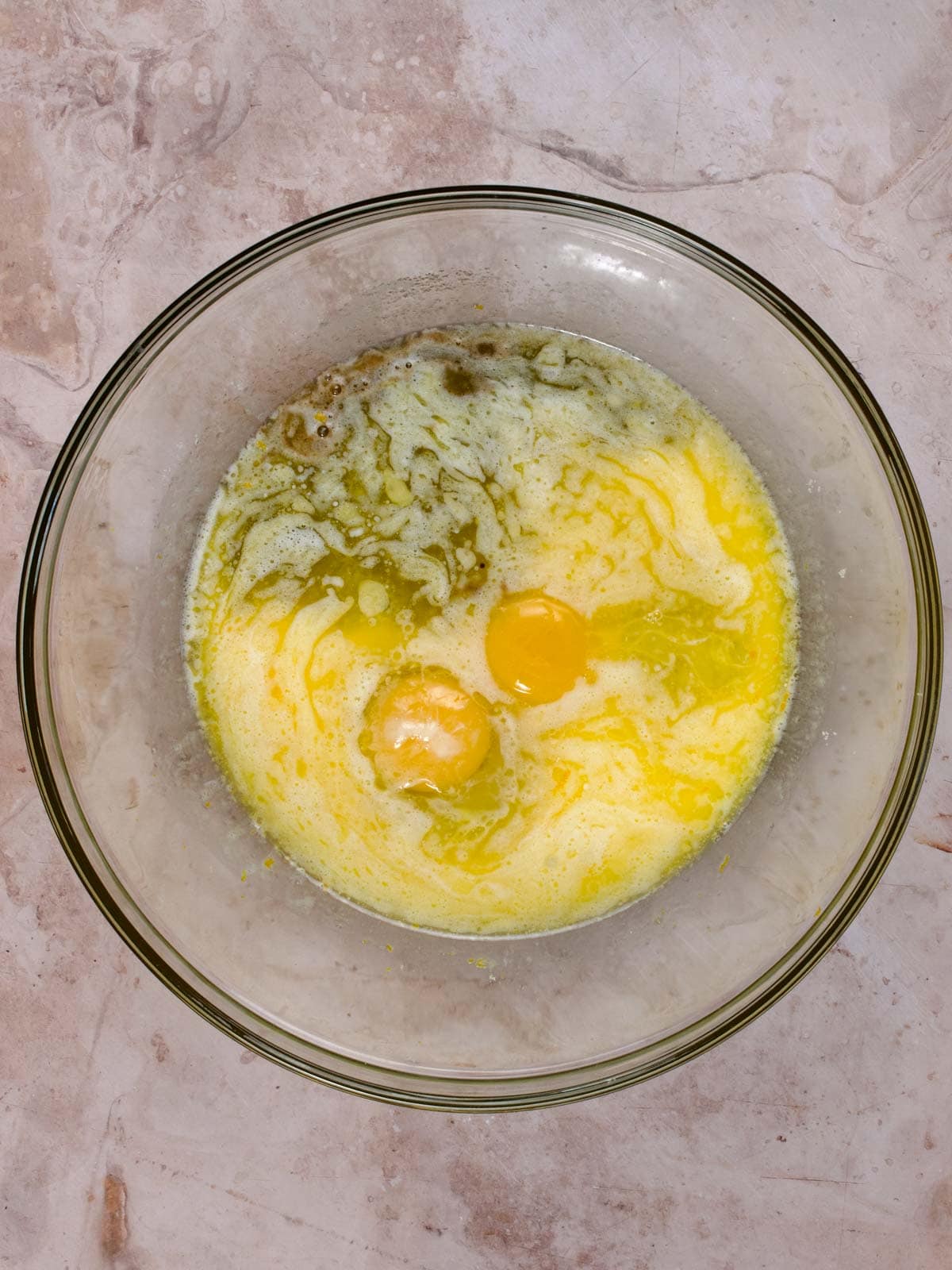 sugar, orange zest, eggs, melted butter, and milk in a bowl