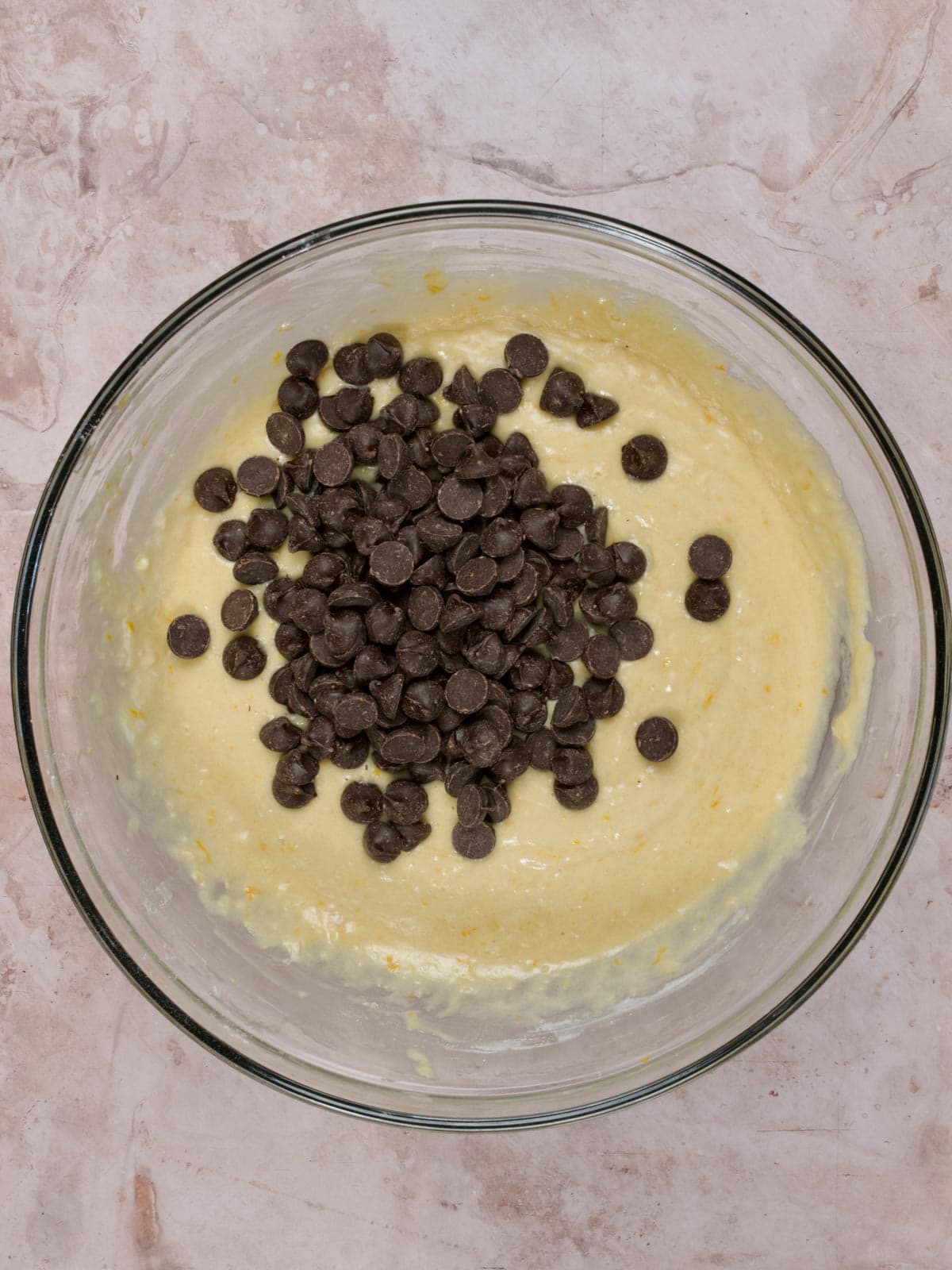 orange muffin batter with dark chocolate chips