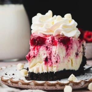 white chocolate cranberry raspberry cheesecake on a plate