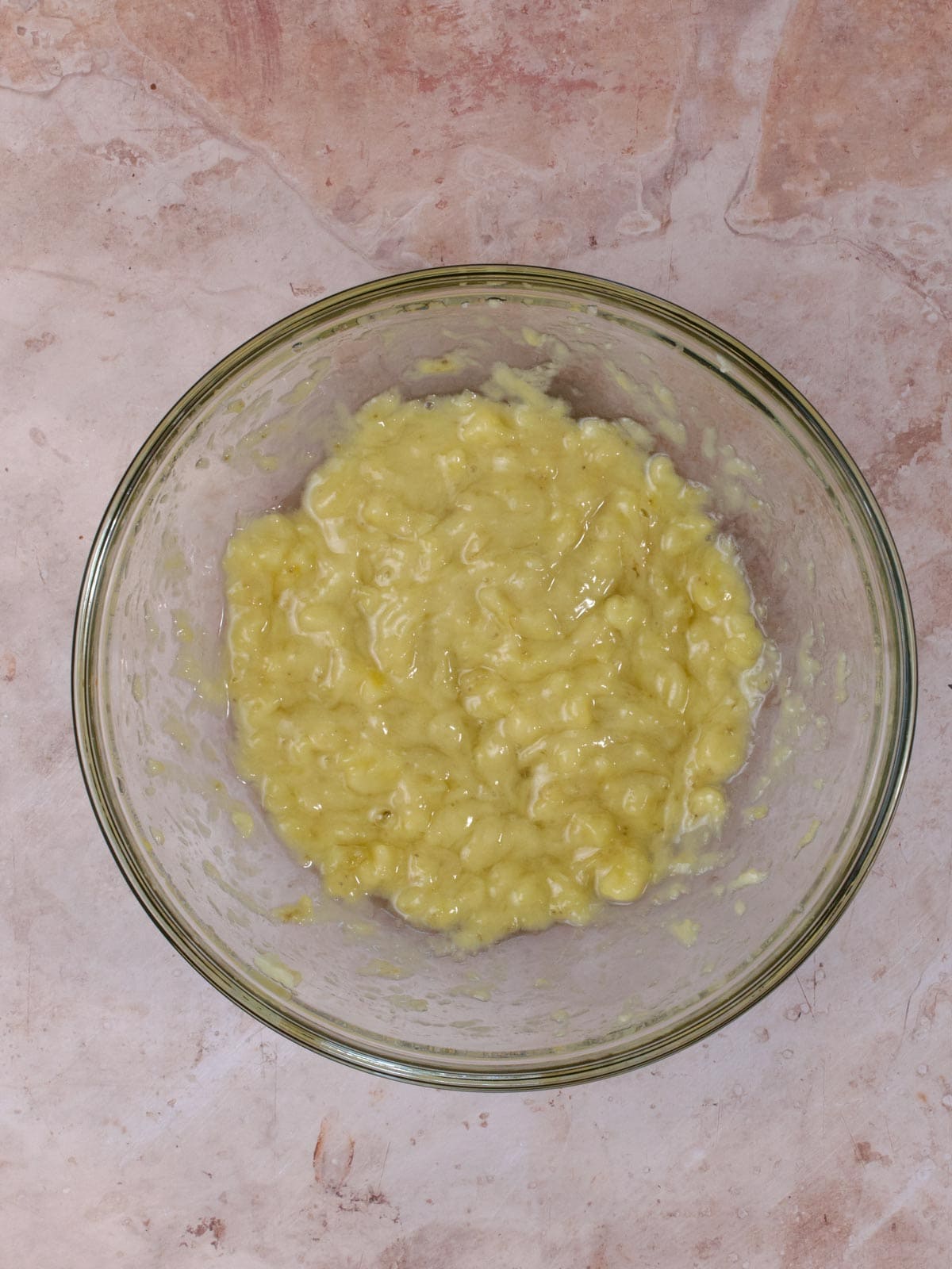 mashed banana in a glass bowl
