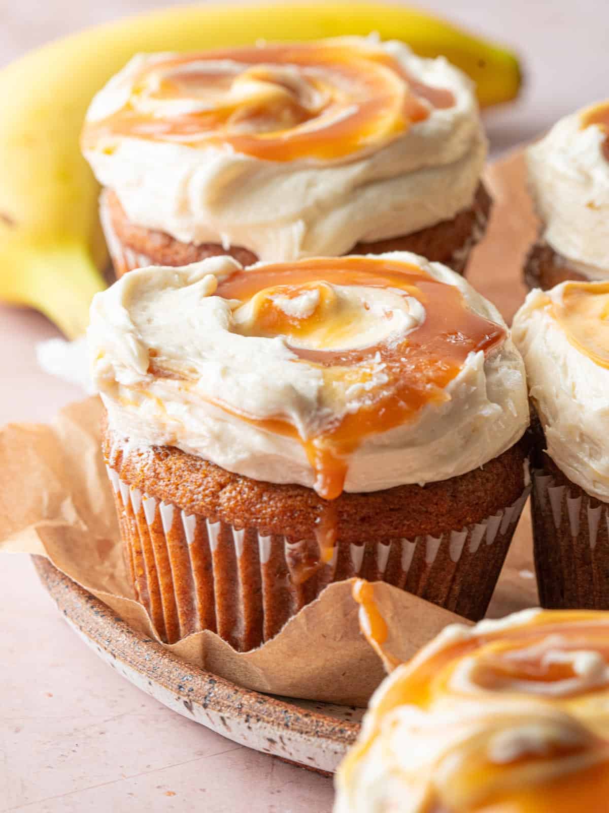 banana spice cupcakes cream cheese frosting salted caramel on a plate