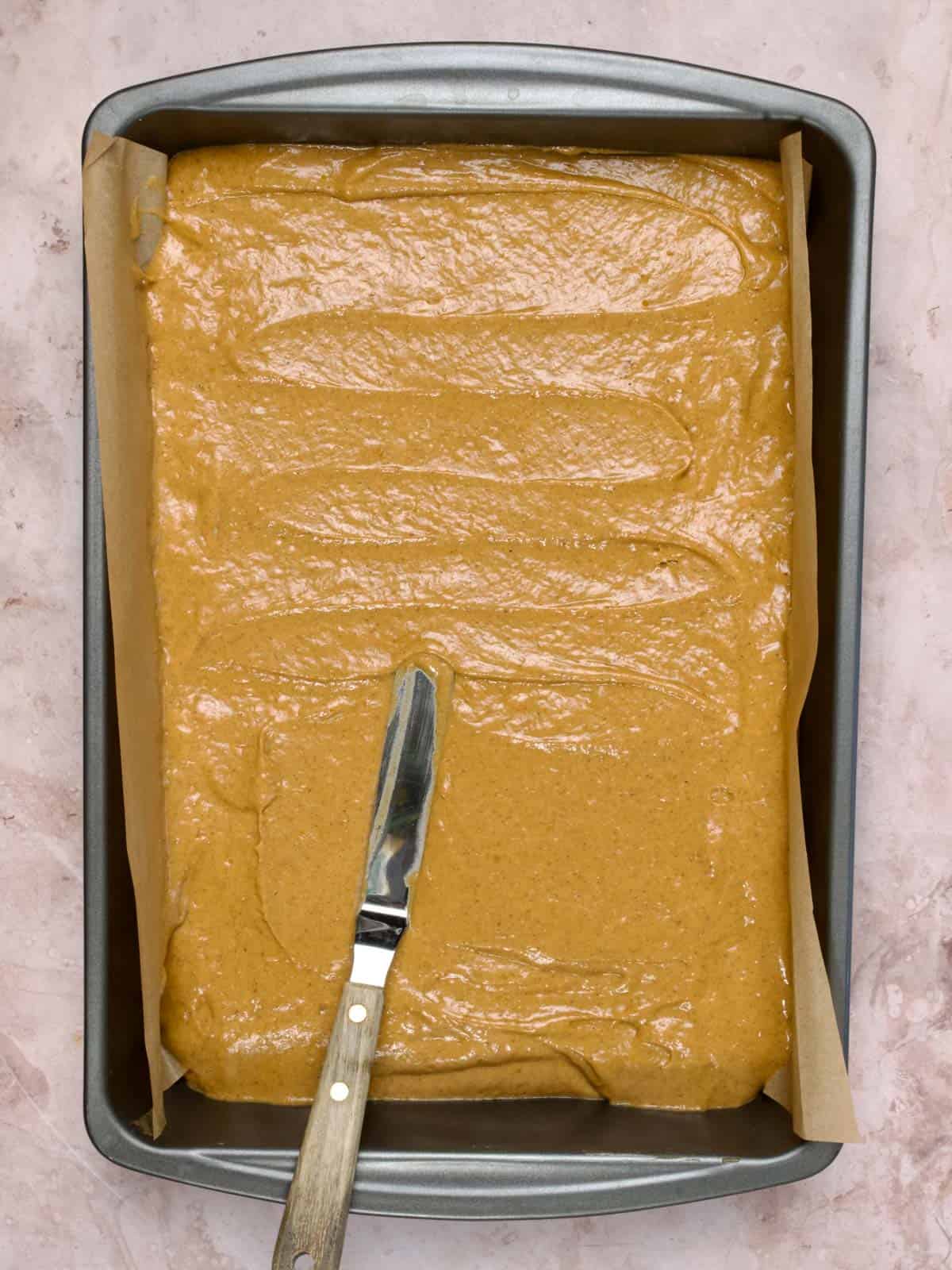 pumpkin cake batter in a sheet pan
