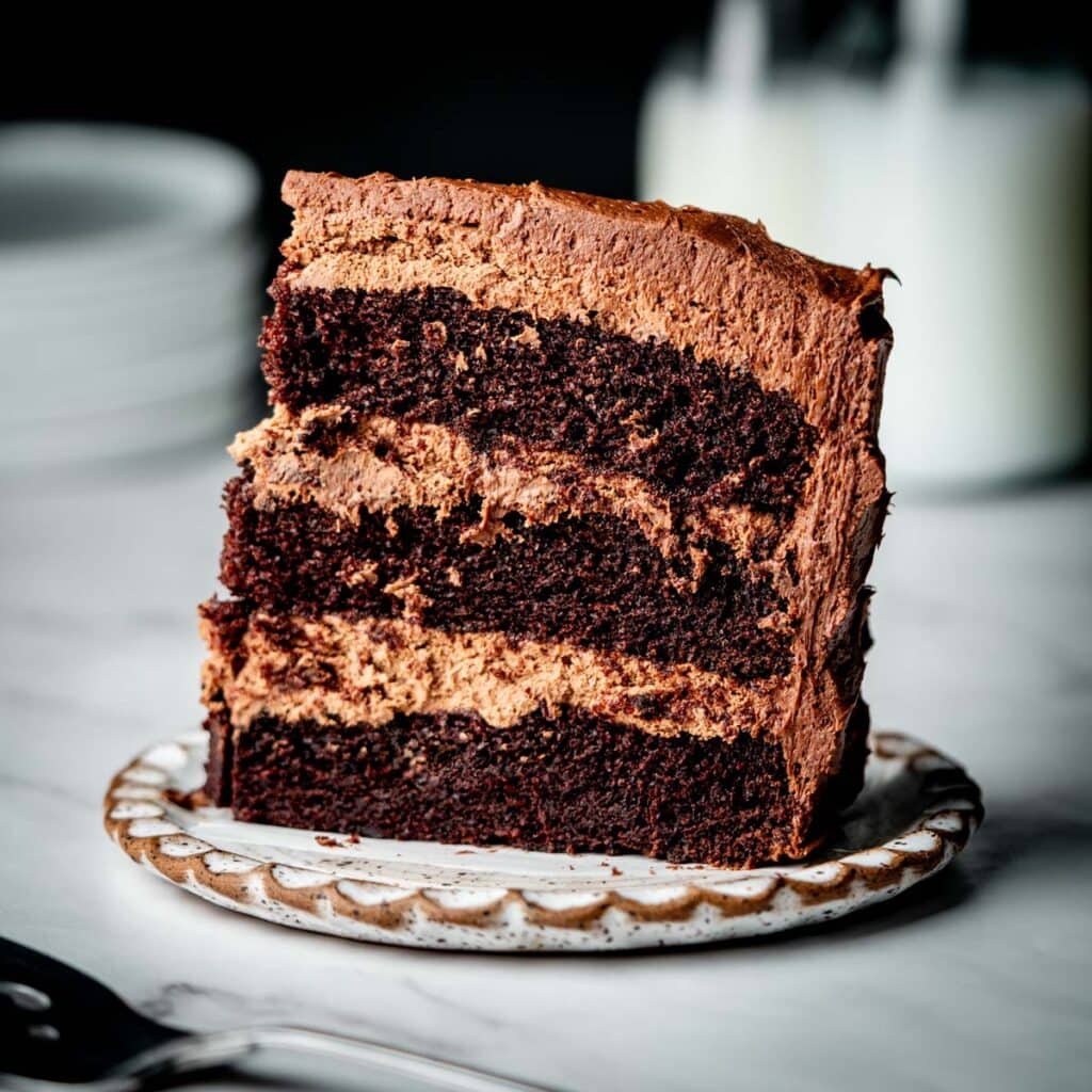 One slice of chocolate chocolate mousse cake on a plate.