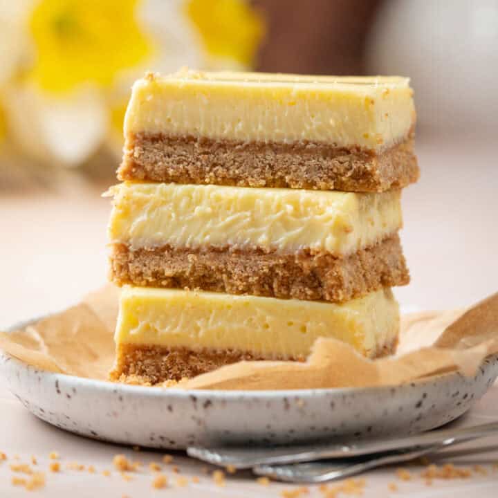 Lemon bars with condensed milk on a plate with a fork.