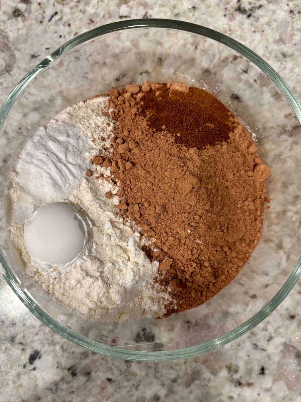 Flour, cocoa, baking soda, salt, and espresso powder in a bowl.