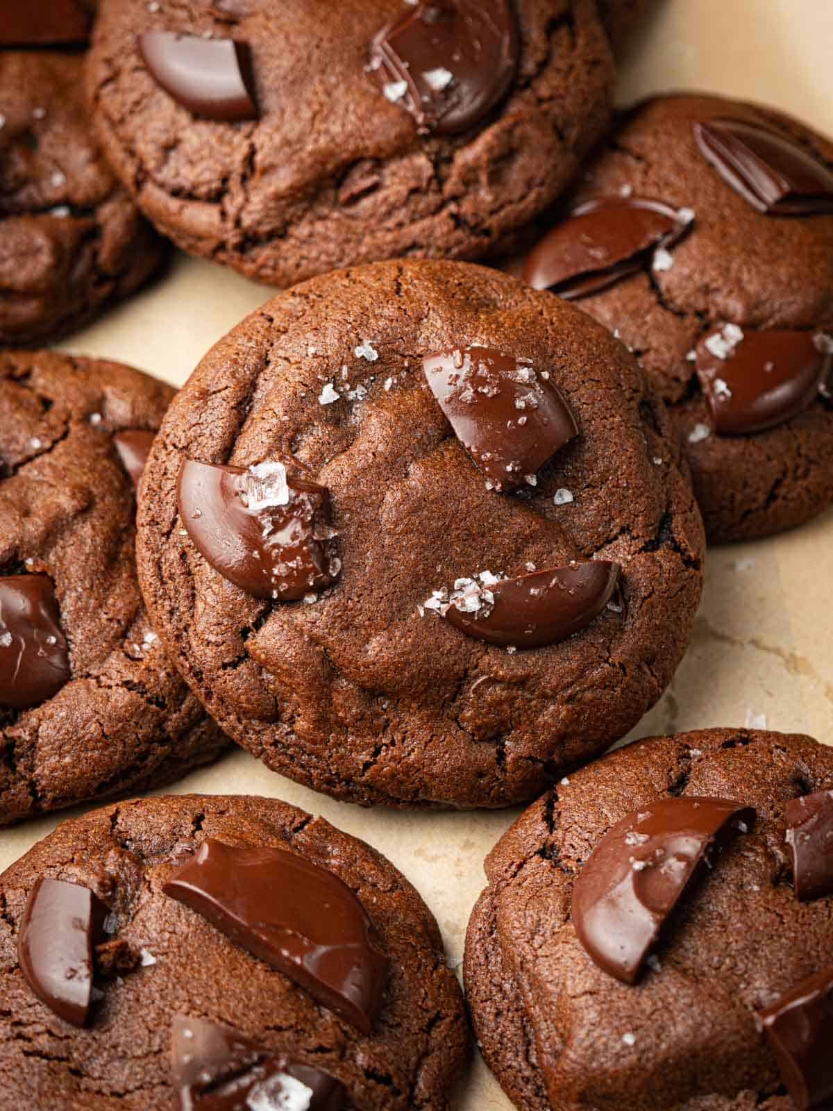 Chocolate chip espresso cookies on a baking sheet with sea salt.