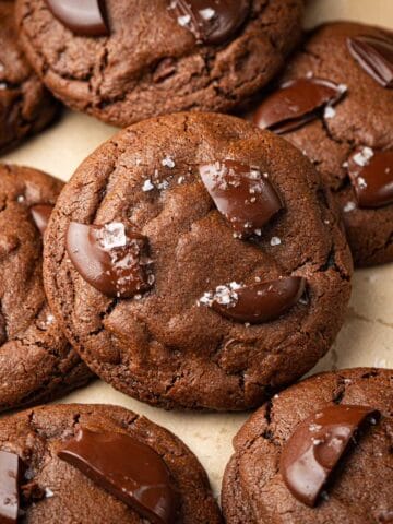 Espresso chocolate chip cookies on a cookie sheet with parchment.