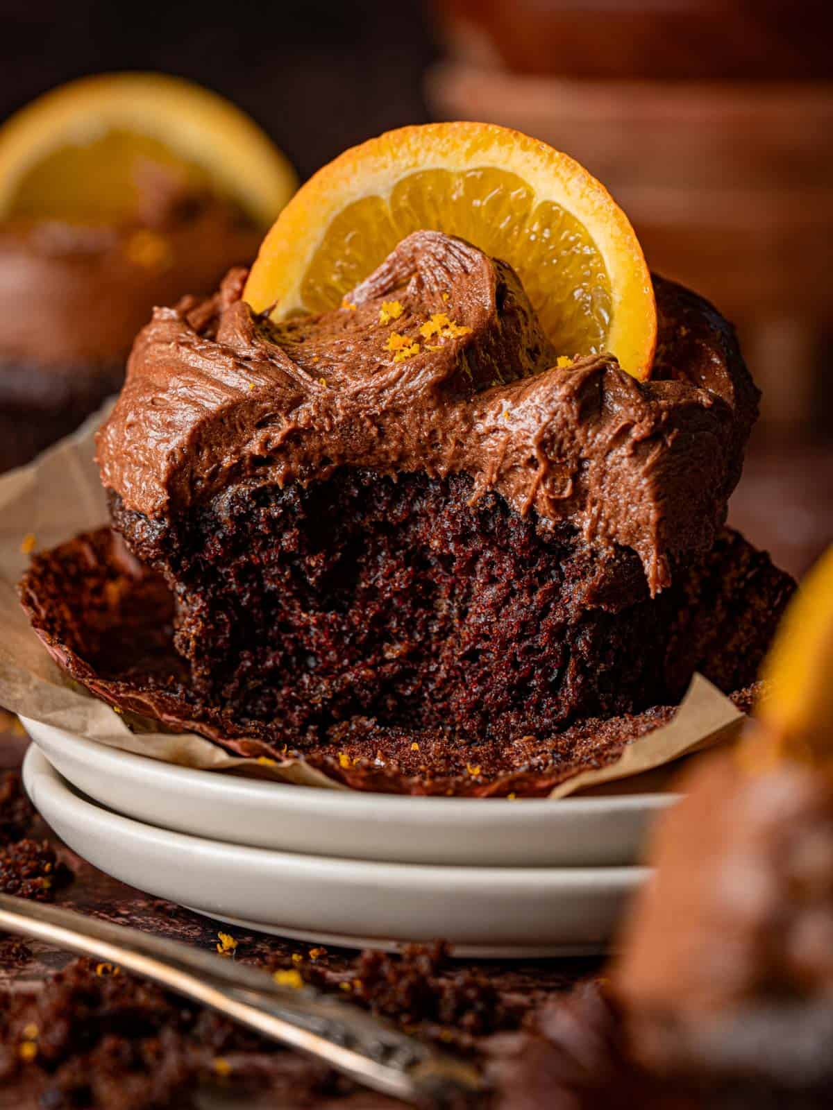 Chocolate orange cupcake with a bite taken out showing the texture.