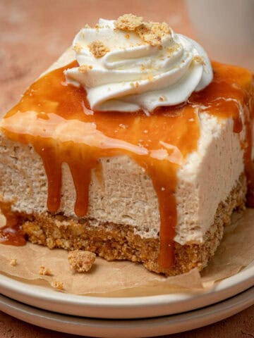 Caramel cheesecake no bake on a plate with caramel on top dripping over the sides.