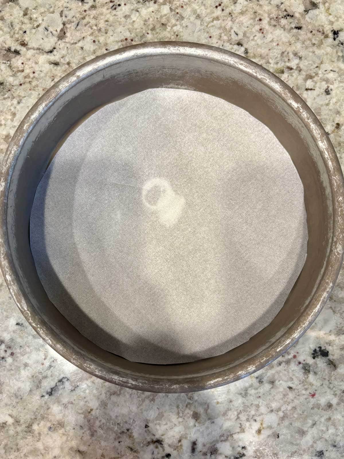 Cake pan with parchment paper on the bottom and greased.