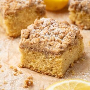 Cardamom coffee cake on parchment paper with crumbs around.