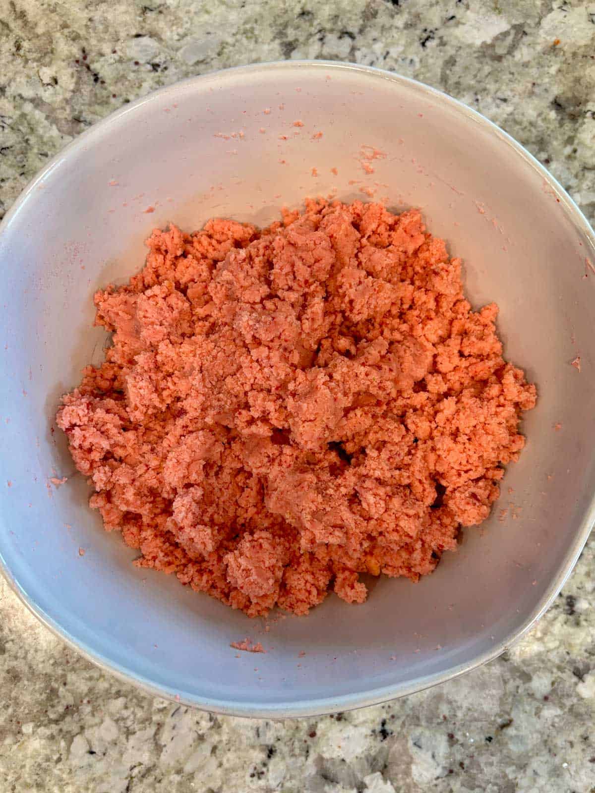 Showing the texture of the cake with the frosting in a large bowl.