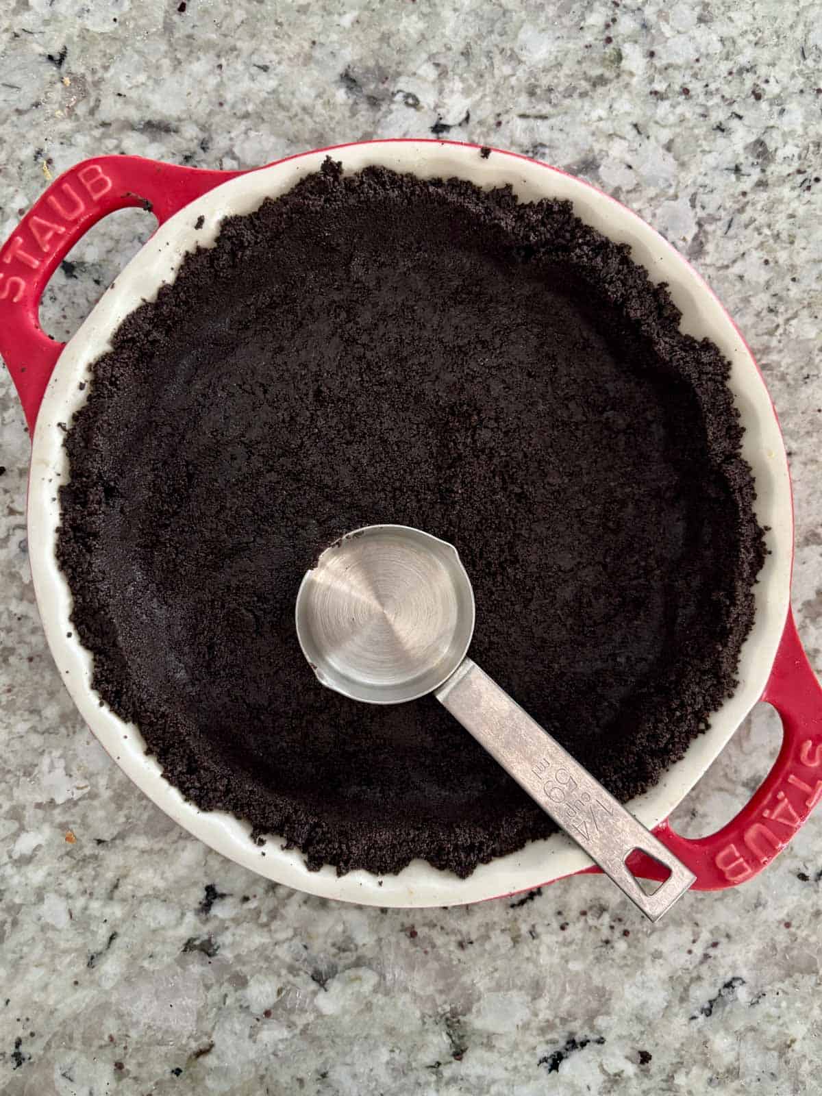 Oreo crust in a pie dish packed until evenly distributed.