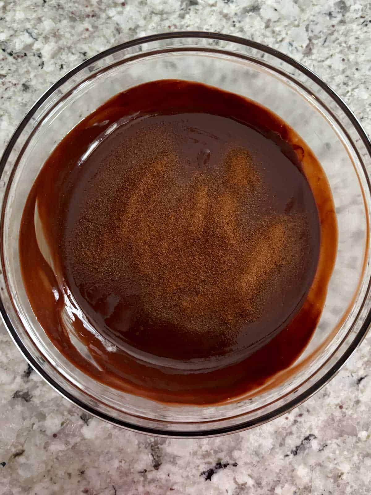 Espresso powder being added to the chocolate butter mixture.