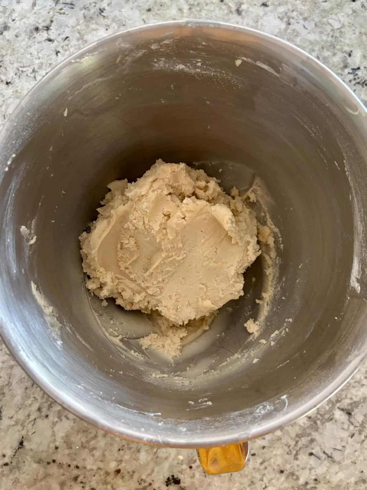 The shortbread dough in a bowl after the flour has been added.