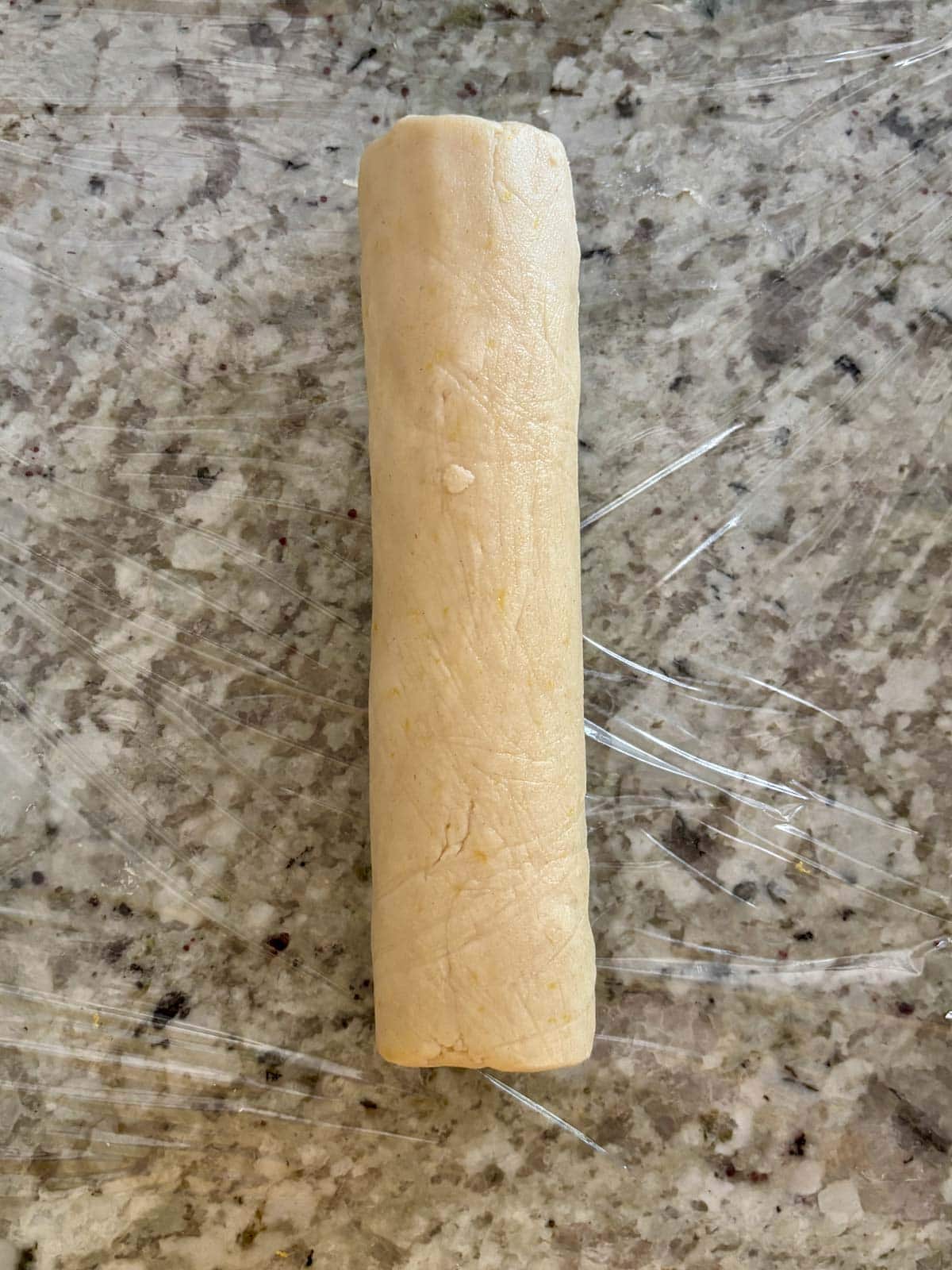 Dough shaped into a log before being refrigerated before slicing.