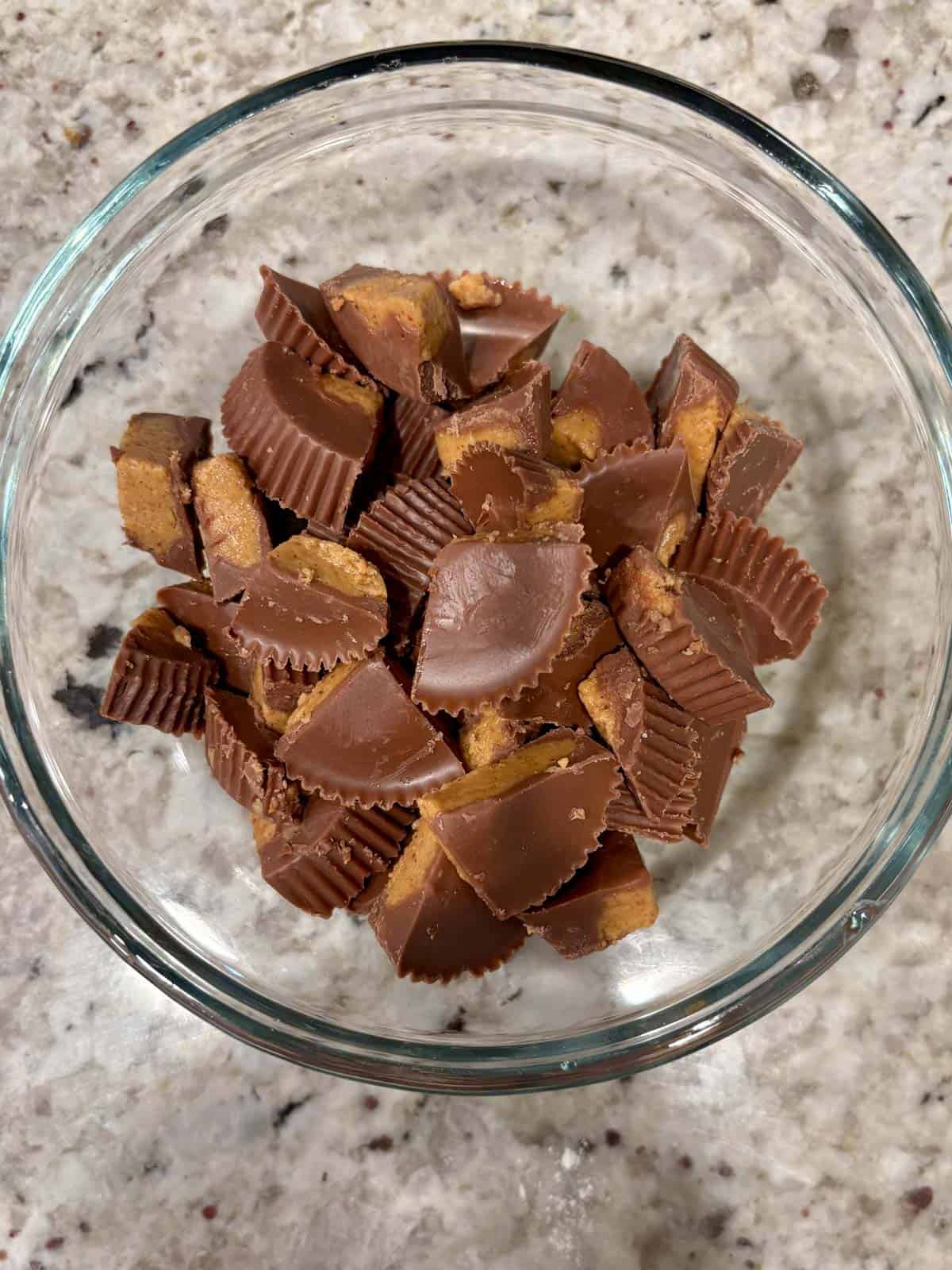 A bowl filled with chocolate covered peanut butter cups.