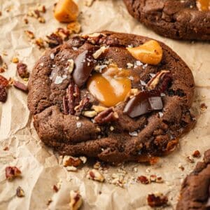 Chocolate cookies with chewy caramels, toasted pecans, and chocolate on top.