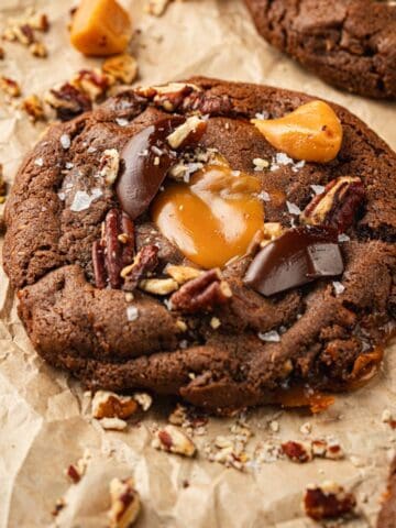 Chocolate cookies with chewy caramels, toasted pecans, and chocolate on top.