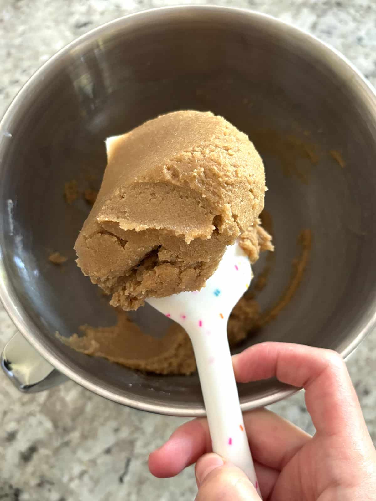 Butter, brown sugar, and granulated sugar being creamed until a paste.