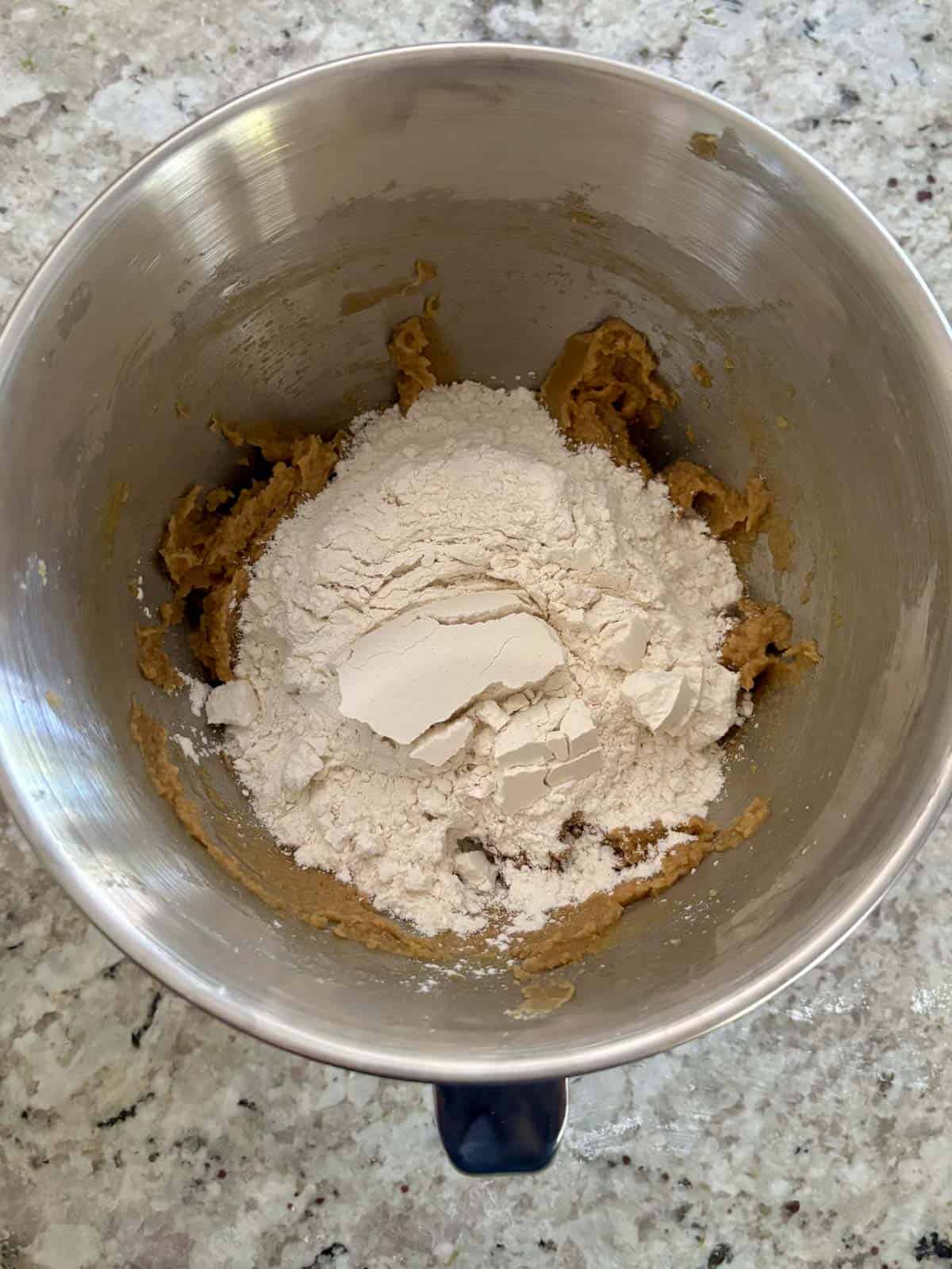 All purpose flour, salt, cornstarch, and baking soda being added to the butter mixture.