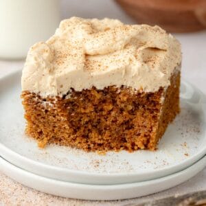 Pumpkin spice cake with espresso buttercream on top on a plate.
