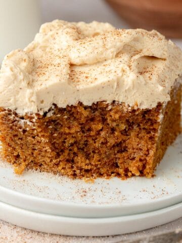 Pumpkin spice cake with espresso buttercream on top on a plate.