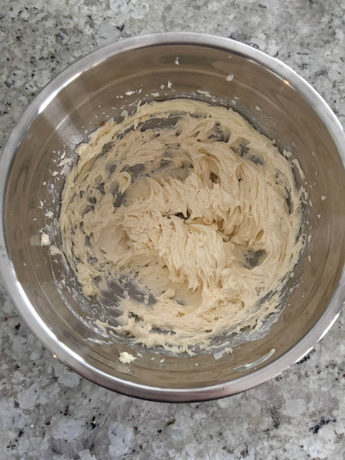 Butter and powdered sugar in a bowl creamed until fluffy.