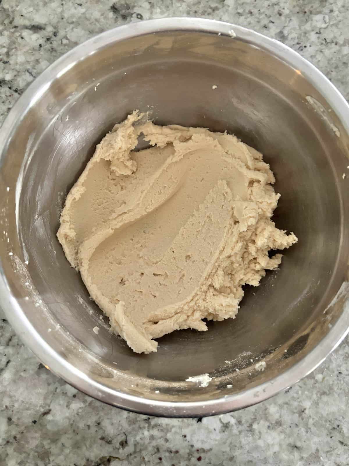 Tart dough in a bowl after being mixed until combined.