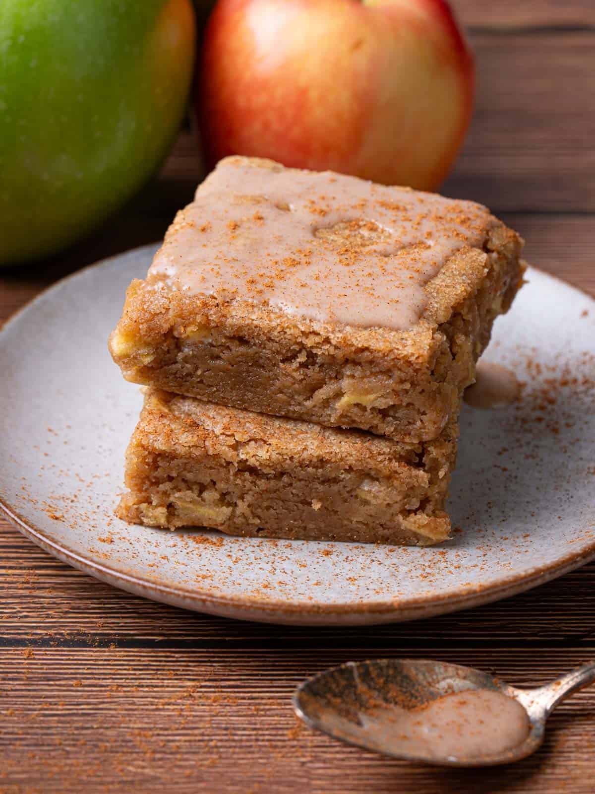 A stack of the apple blondies with cinnamon glaze on top.