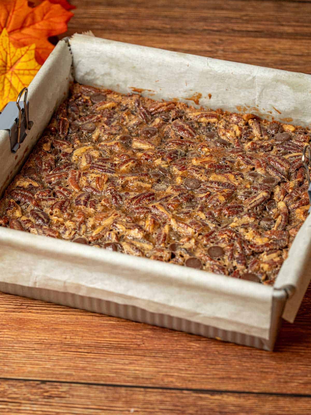 The finished bars in a pan with parchment paper showing the top once its set.