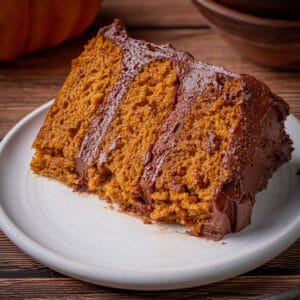 Pumpkin chocolate cake slice on a plate with a fork.