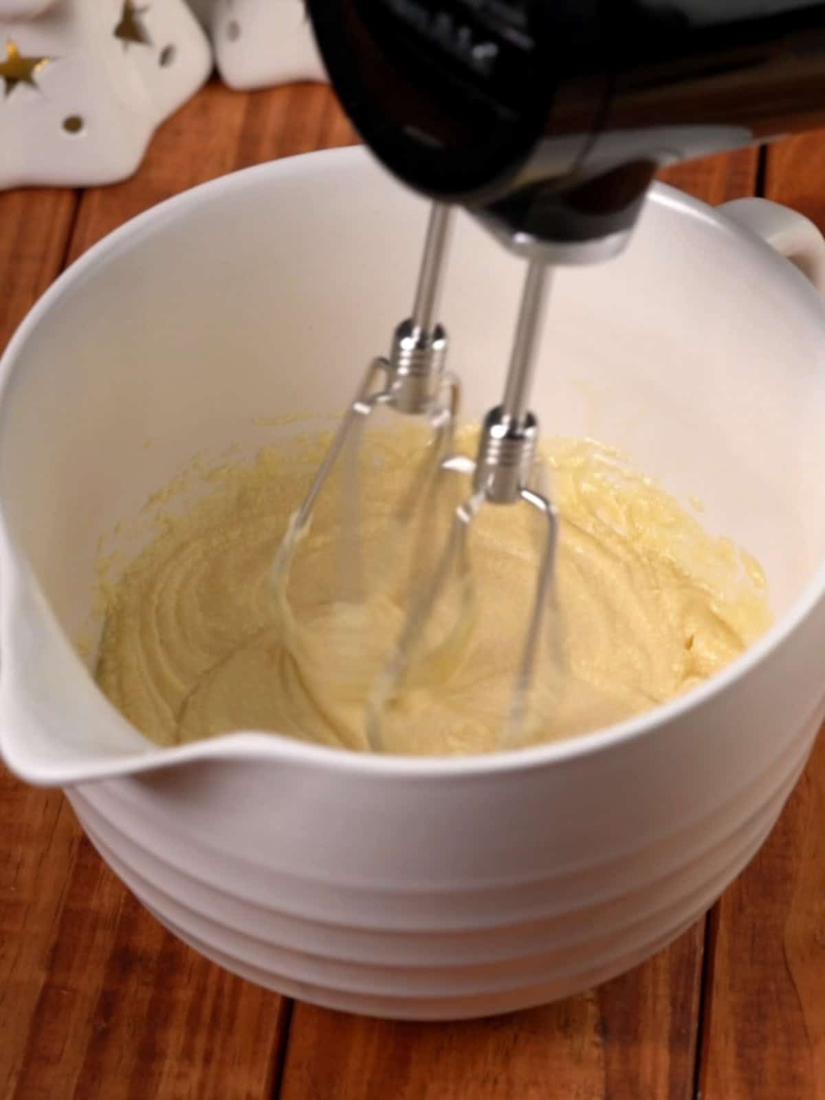 Beating the eggs, butter, and sugars together in a bowl.