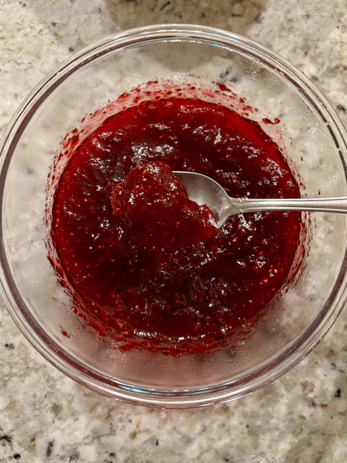 Cranberry jam in a bowl after being cooked down.