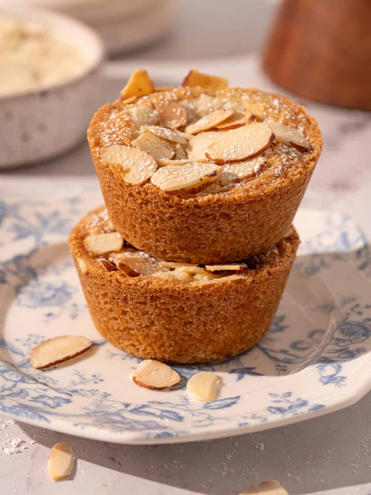 Stacked cookie cups on a plate with almond flour in the background.
