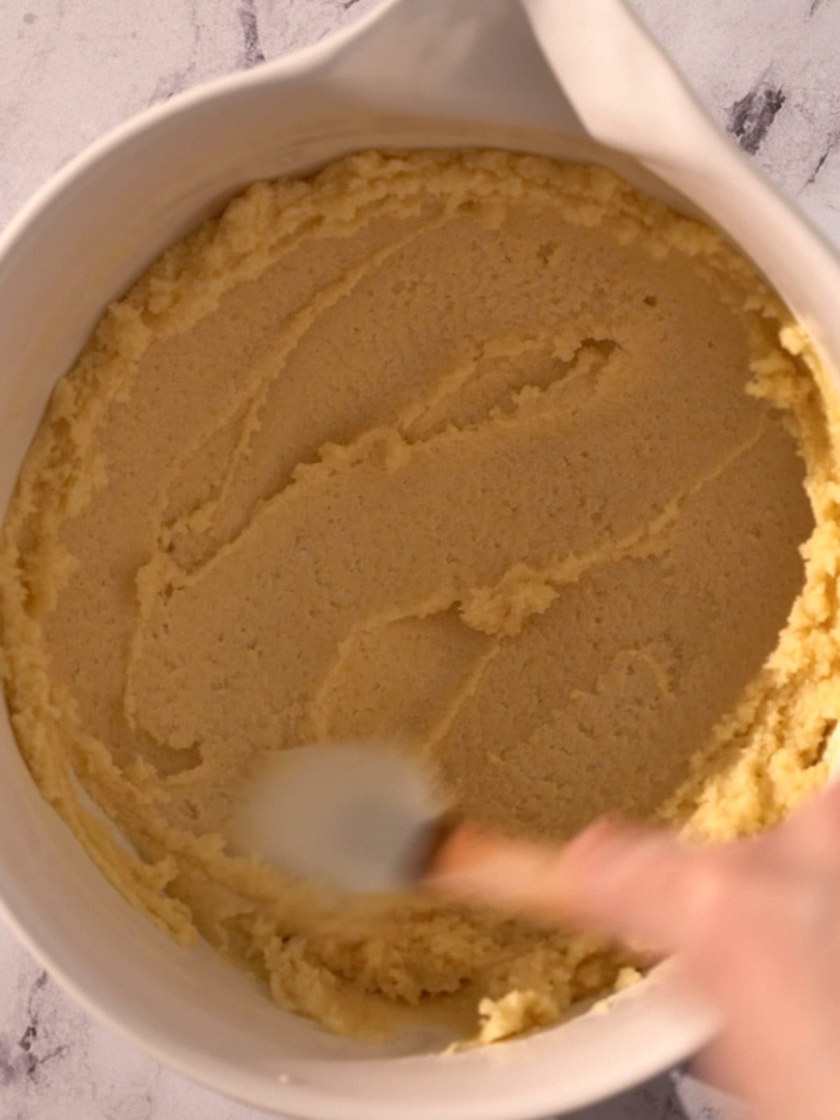 Almond frangipane cookie filling in a bowl being mixed.