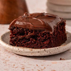 Chocolate espresso cake on a plate with espresso fudge frosting.