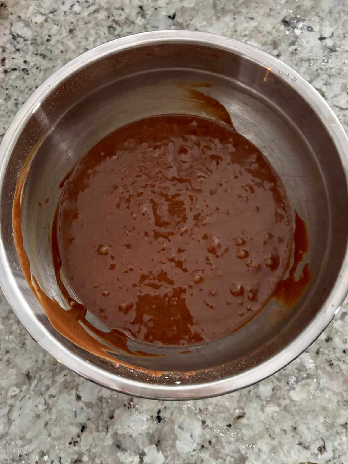 Chocolate cake batter in a bowl after the hot coffee was added to it.