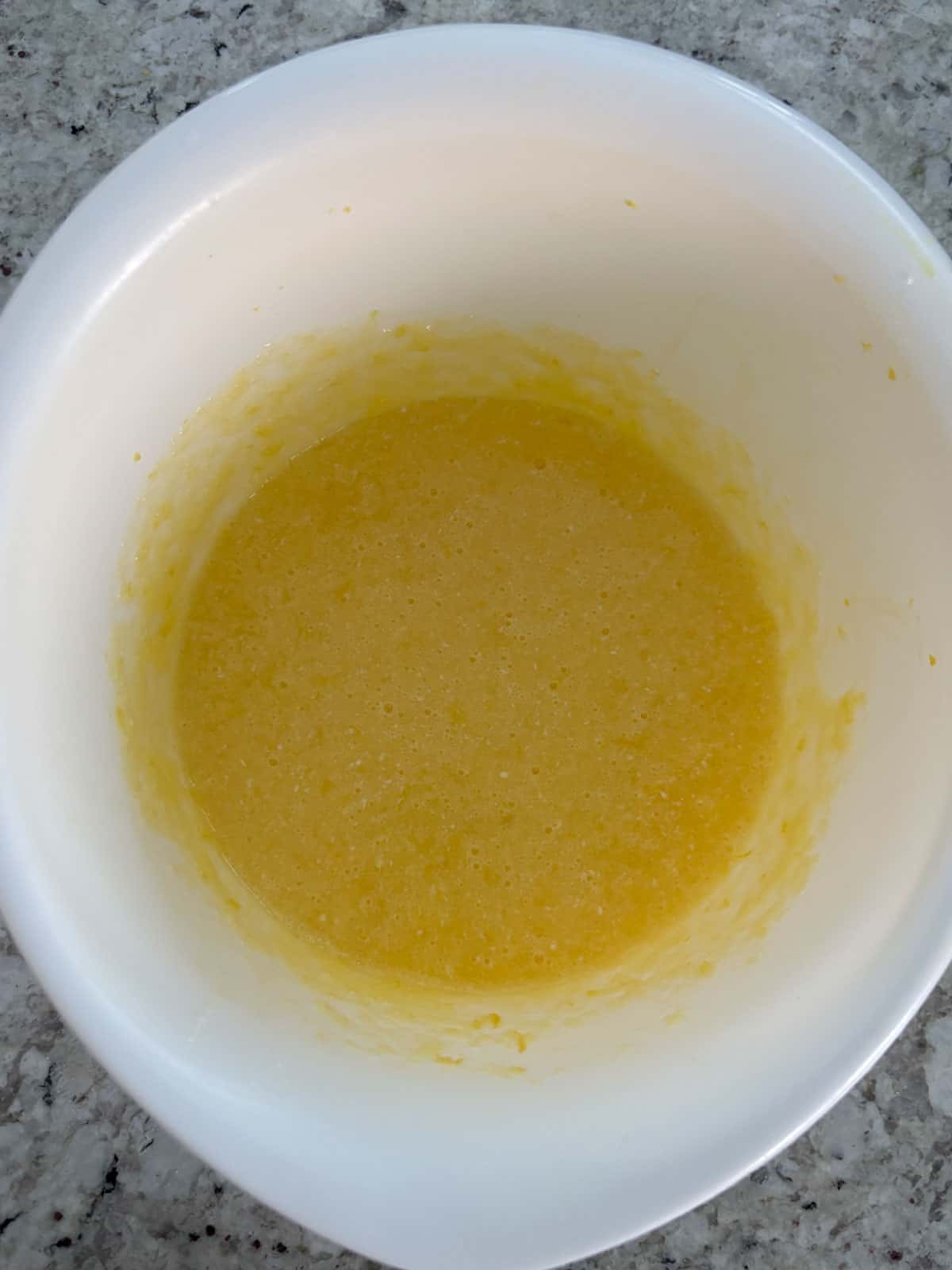 All of the wet ingredients mixed together in a white bowl.