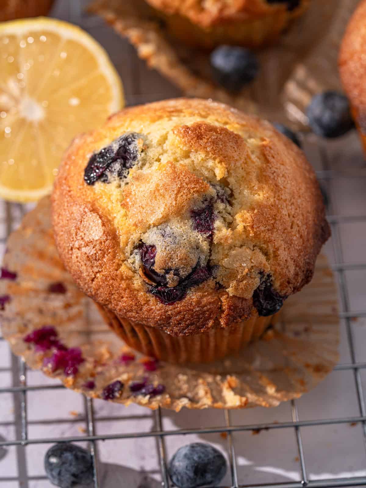 Showing the muffin top of the a bakery style muffin on a rack.
