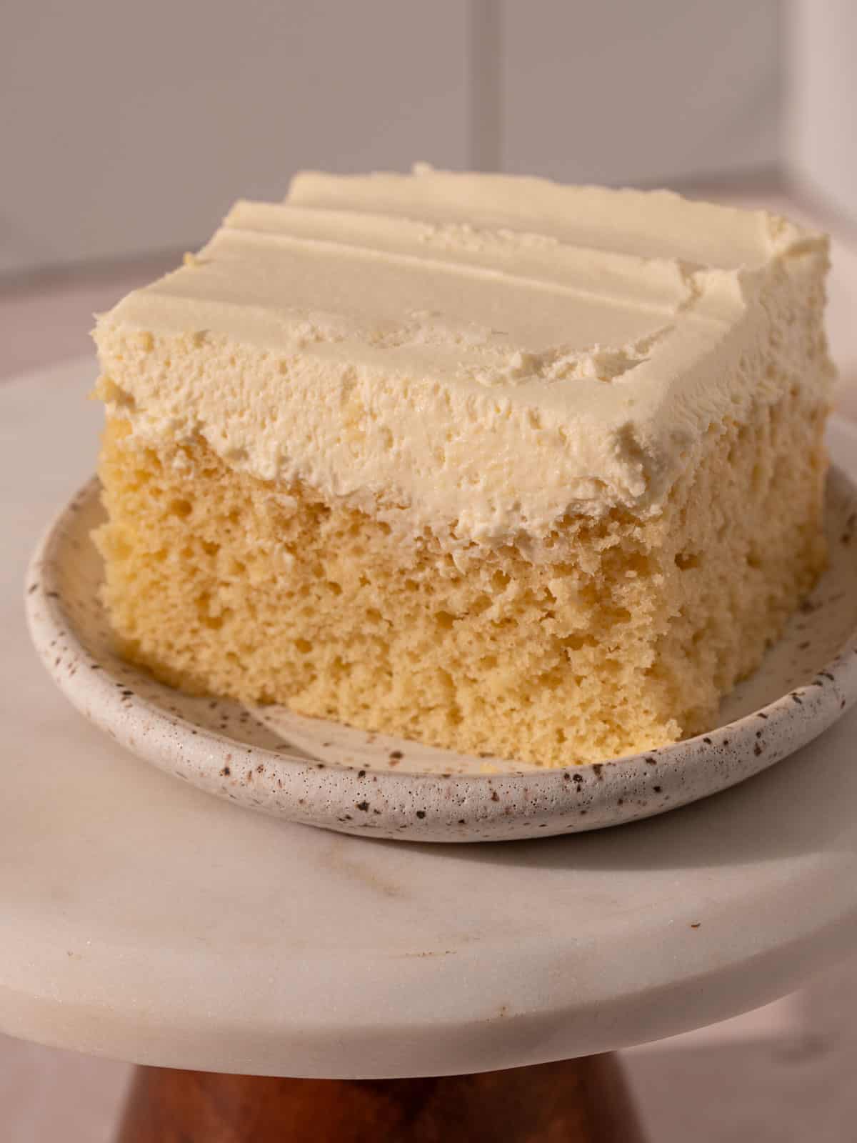White chocolate mousse cake on a plate showing the texture.