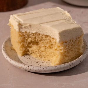 Cake with mousse filling on a plate with a bite taken out.