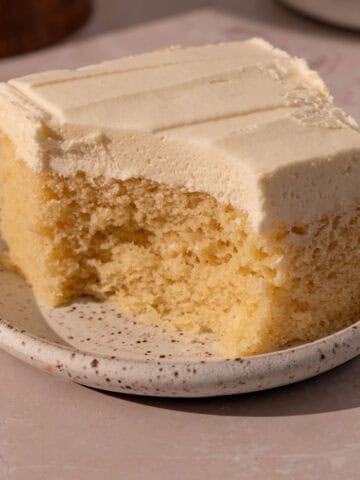 Cake with mousse filling on a plate with a bite taken out.