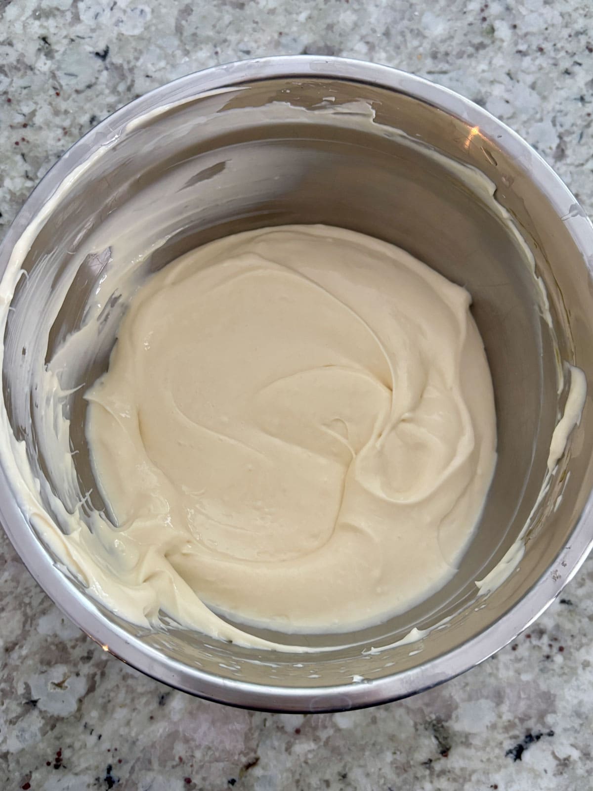 Vanilla cheesecake batter in a bowl smooth and creamy.