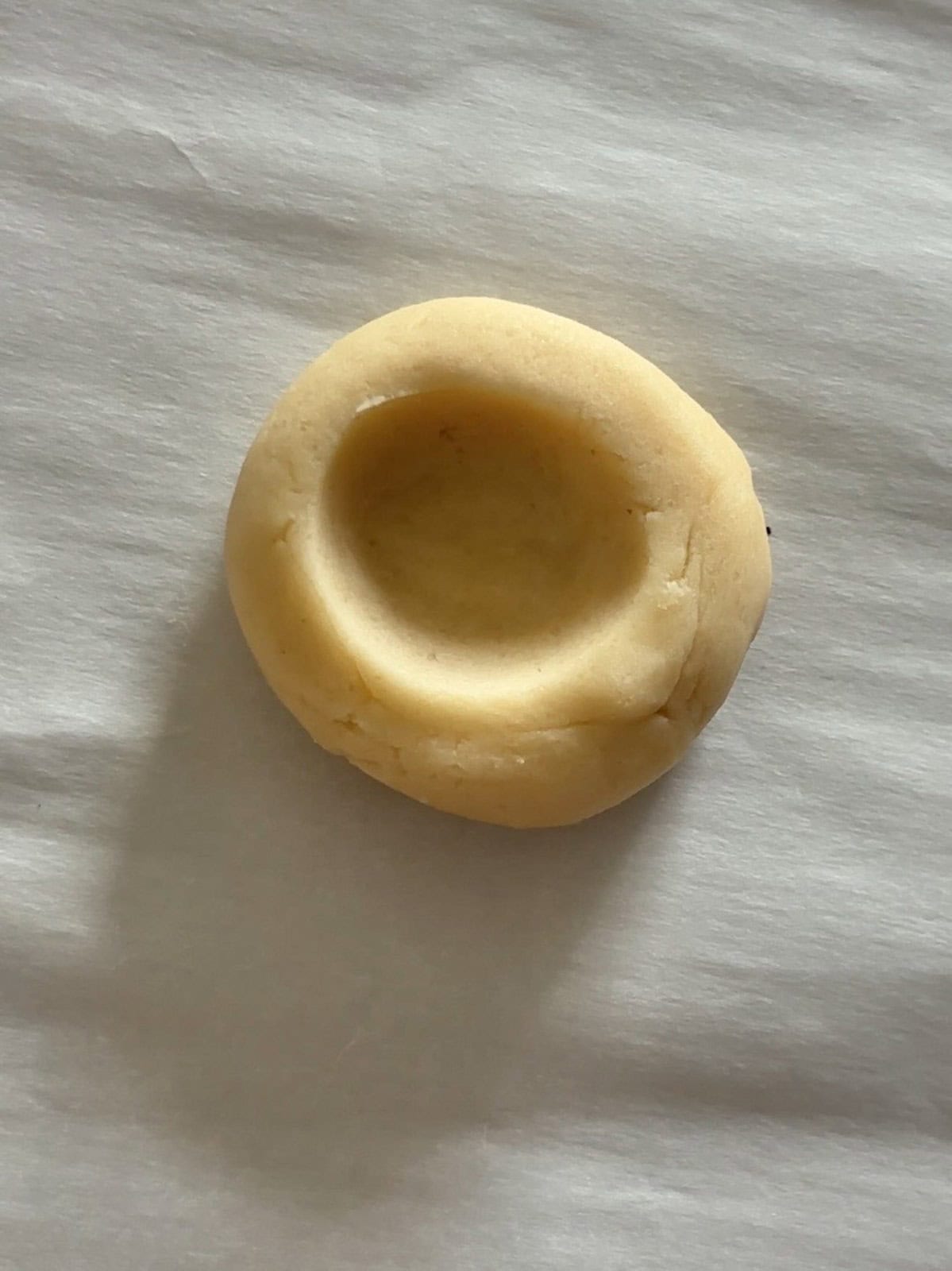 An indent in the cookie dough for the lemon curd.