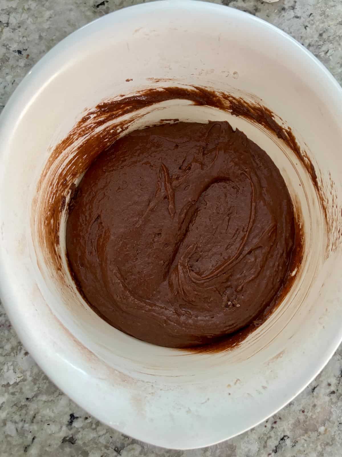The wet ingredients added to the dry ingredients for the chocolate cake batter.