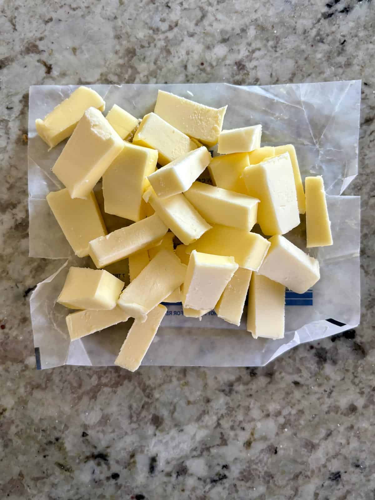 Butter cut into cubes on the counter.